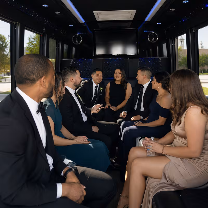Wedding guests seated inside a Garland party bus