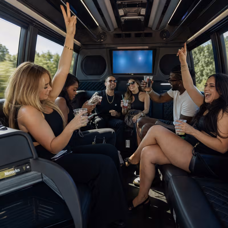 Group boarding a white charter bus for Concert Transportation transportation in Garland
