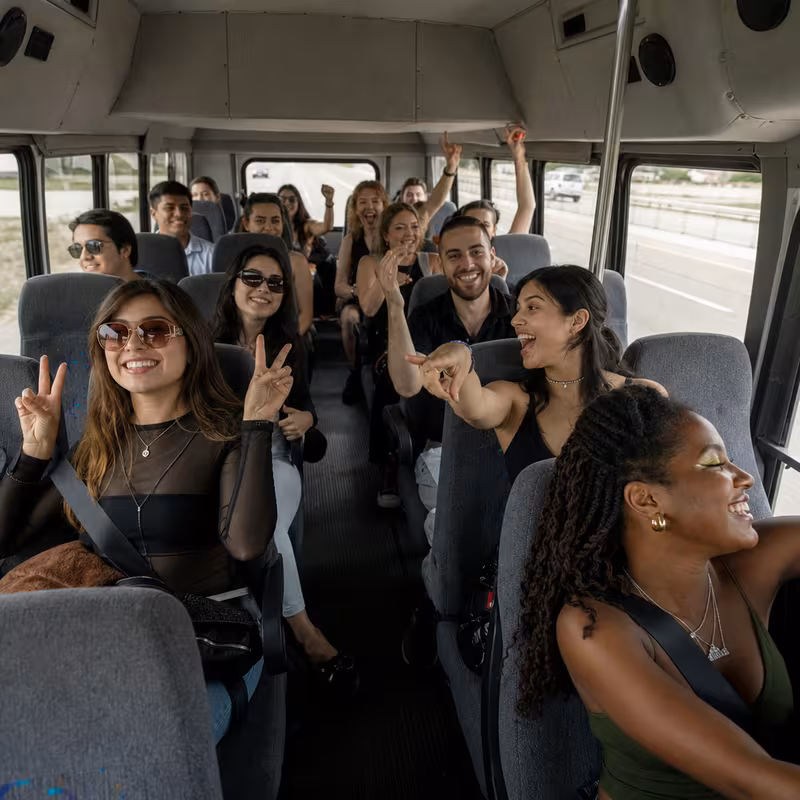 Party bus interior with wraparound leather seating and LED lighting in Garland