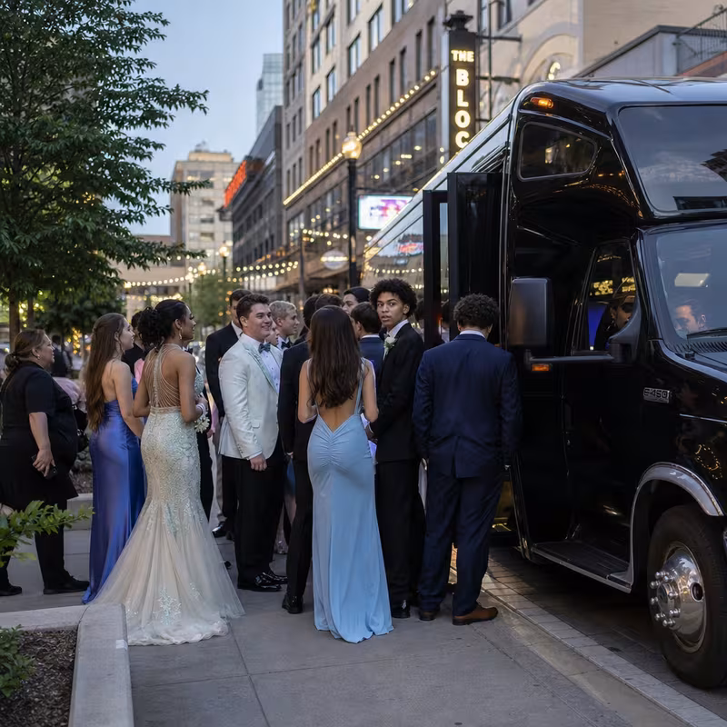 Passengers loading luggage while boarding an Garland group shuttle