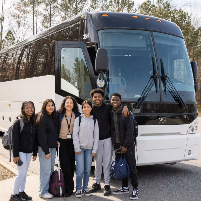 Passengers loading luggage while boarding an Garland group shuttle