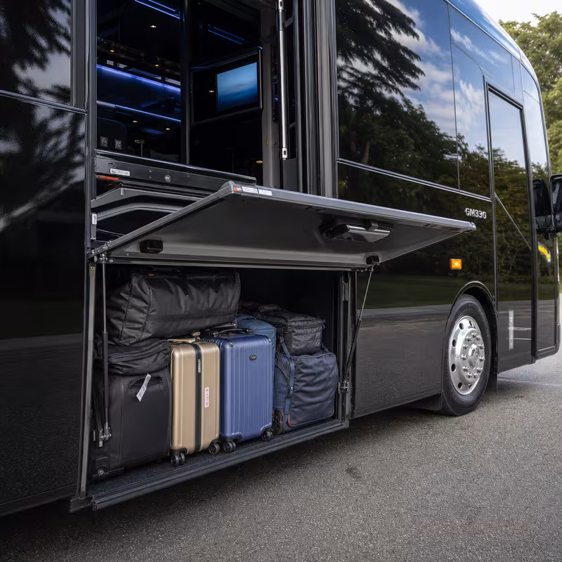 Party bus interior with wraparound leather seating and LED lighting in Garland