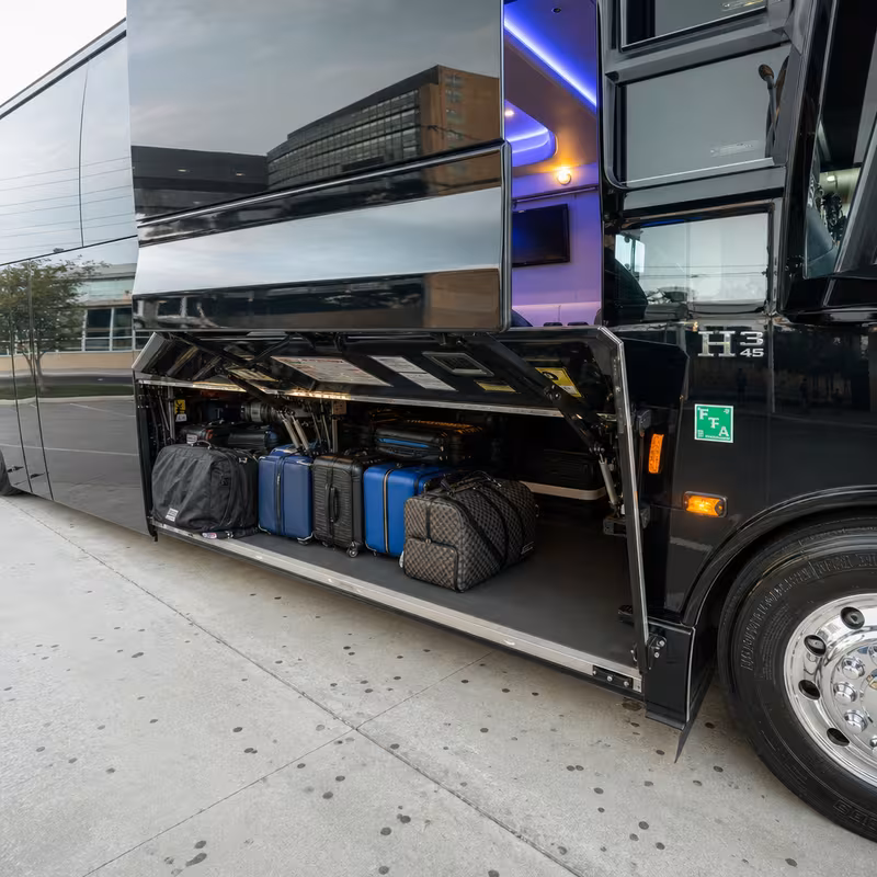 Party bus interior with wraparound leather seating and LED lighting in Garland