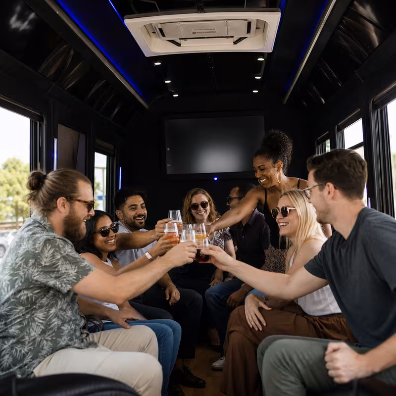 Group boarding a white charter bus for Winery & Brewery Tour Transportation transportation in Garland
